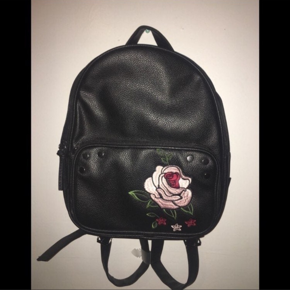 Black leather backpack with a flower design